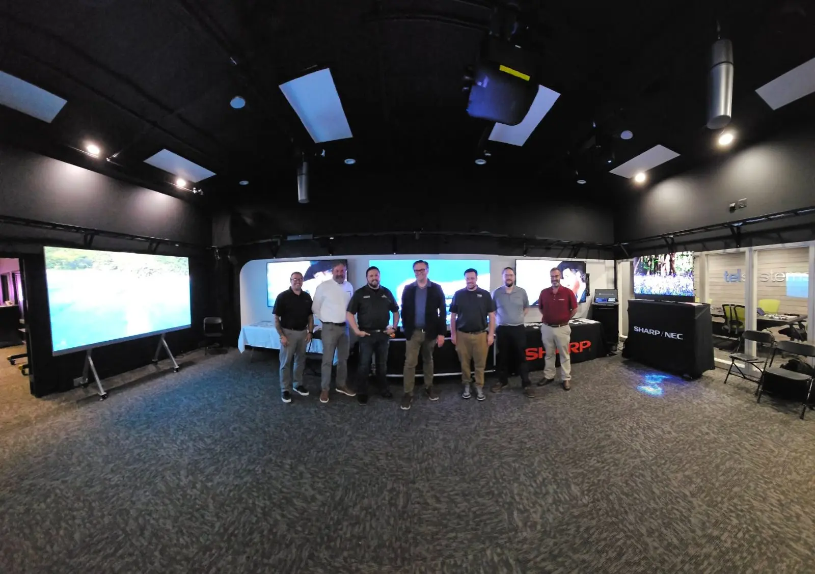 Thalner project managers and engineers reviewing an AV system design in our Ann Arbor demo room